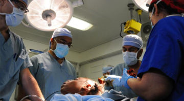Sanjay Gupta, Henri Ford, and two U.S. Navy doctors operate on a Haitian girl aboard the USS Carl Vinson following the January 2010 earthquake in Haiti.