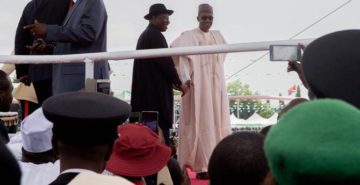 "Incoming and Outgoing Nigerian Presidents Wave to Crowd Amid Peaceful Inaugural in Abuja" by U.S. Department of State - https://www.flickr.com/photos/statephotos/18049528180/. Licensed under Public Domain via Wikimedia Commons.