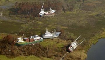 Bayou La Batre: nave cargo e barche da pesca portate sulla terraferma dalle acque "Katrina Bayou La Batre 2005 boats ashore" di NOAA, agency of US Federal Government