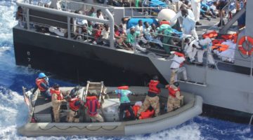 Rescued migrants, October 2013. By Official U.S. Navy Page from United States of America U.S. Navy photo/ Public Domain, https://commons.wikimedia.org/w/index.php?curid=30912042 Rescued migrants, October 2013