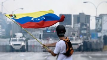 Protester facing the Venezuelan National Guard during a protest in May 2017. by Efecto Eco (CC By 3.0)
