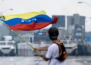 Protester facing the Venezuelan National Guard during a protest in May 2017. by Efecto Eco (CC By 3.0)